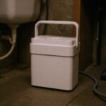 Midea Cube 50 Pint dehumidifier with pump near a drain
