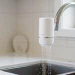 Waterdrop WD-FC-01 faucet water filter mounted on a kitchen faucet