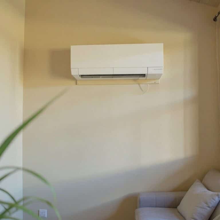 A ductless mini-split indoor unit mounted on a living room wall