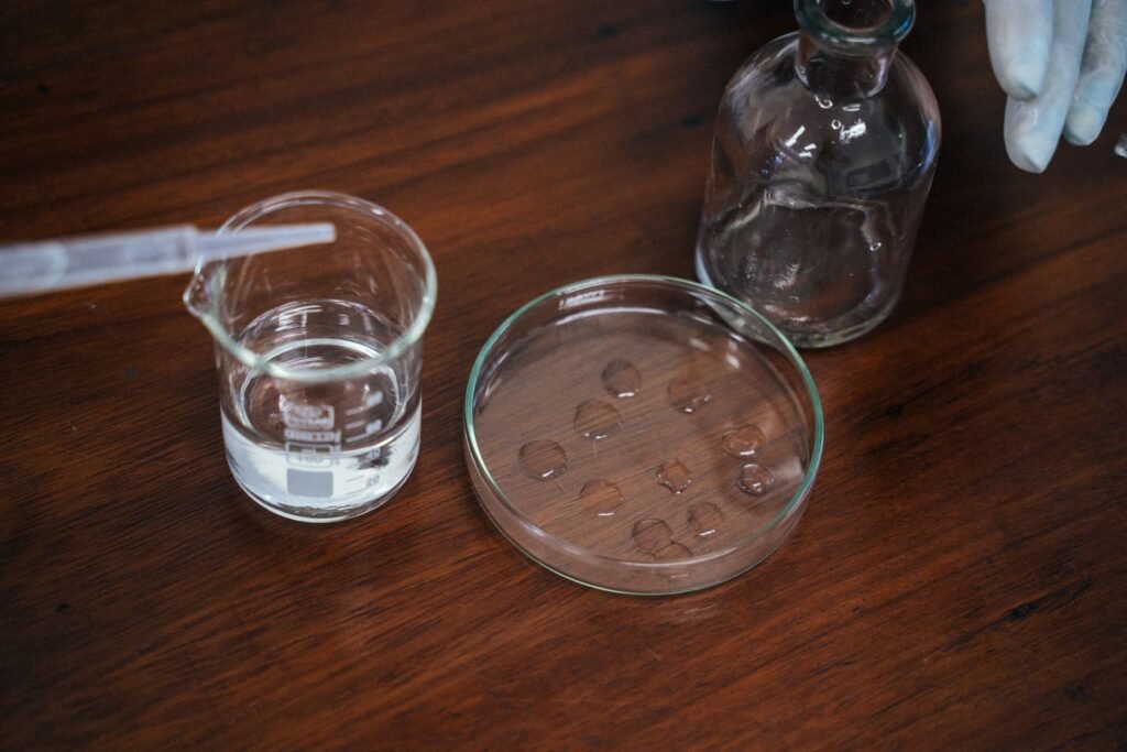 What Ontario's Free Well Water Test Actually Checks (and What It Doesn't) 1 Well Water Testing Ontario — Water sample being tested in glass lab beakers on a wooden bench