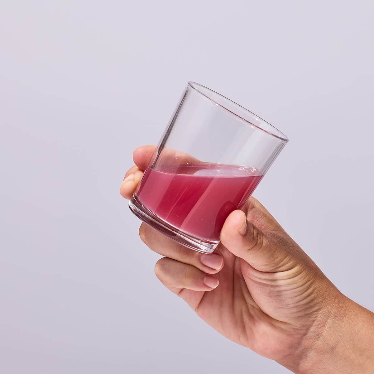 Holding a glass of the mixed Isotonix OPC-3 Beauty Blend drink