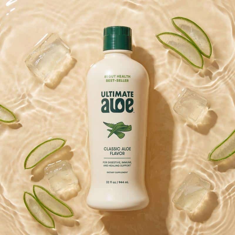 Isotonix Ultimate Aloe Classic Aloe flavor bottle chilled on ice with fresh aloe leaf slices